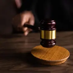 Młotek sędziowski na drewnianym stole. Sąd bada upadłość konsumencką, analizując sytuację dłużnika.